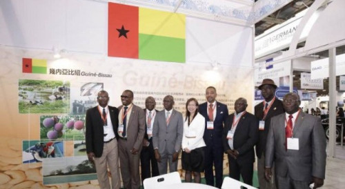 Guests visit Guinea-Bissau’s booth at the Pavilion