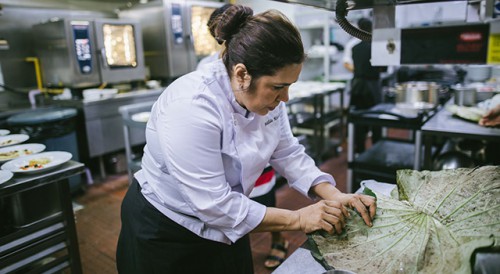 Brazilian chef preparing seafood on a shell